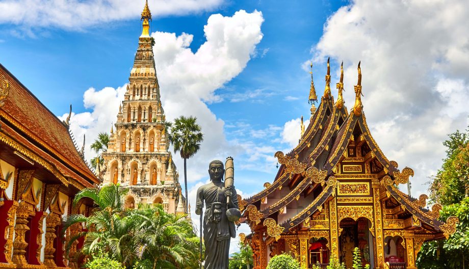 Golden Thai temples and stupa under a Bangkok sky